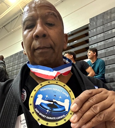 Sensei Anthony showing his Positive Impact medal