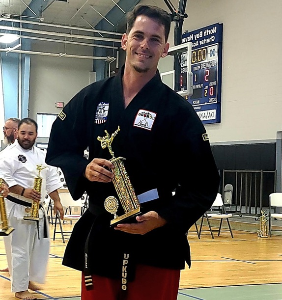 Sensei Daniel Boydston poses with his trophy.